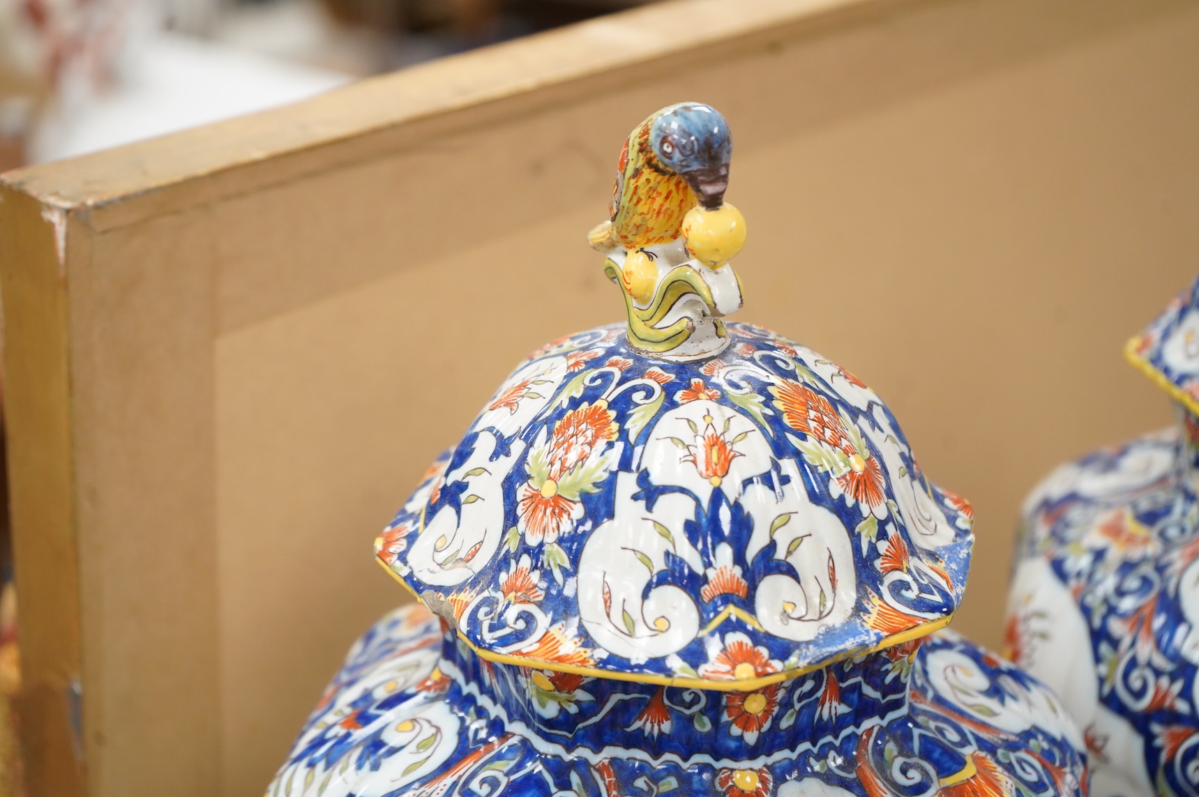 A pair of early 20th century Rouen faience vases and covers, the knops in the form of birds, 49cm high